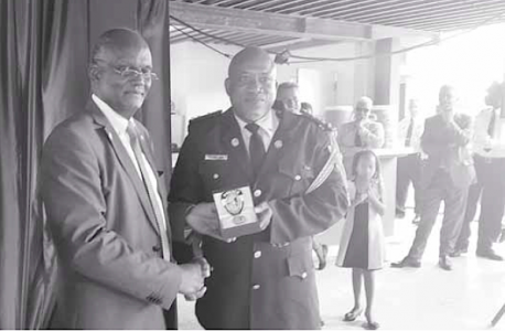 Op de foto commissaris Carl John (rechts) met minister van Justitie Dennis Richardson in juni