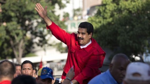 Venezuela's President Nicolas Maduro waves to supporters after the inauguration of cable car public transportation system, in the popular neighborhood of Petare, in Caracas, Venezuela, Tuesday, Dec. 1, 2015. As the country heads to congressional elections on Sunday, the opposition might gain control of the National Assembly for the first time since 1998, and serve the socialist party founded by late President Hugo Chavez its first ever loss in a nationwide contest for public office. (AP Photo/Ariana Cubillos)